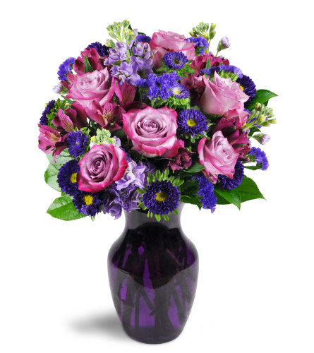 Lovely Lavender™ - Deluxe. An arrangement by Fine's Flowers. Sweet lavender roses are cheerfully displayed with alstroemeria, asters, stock, and...